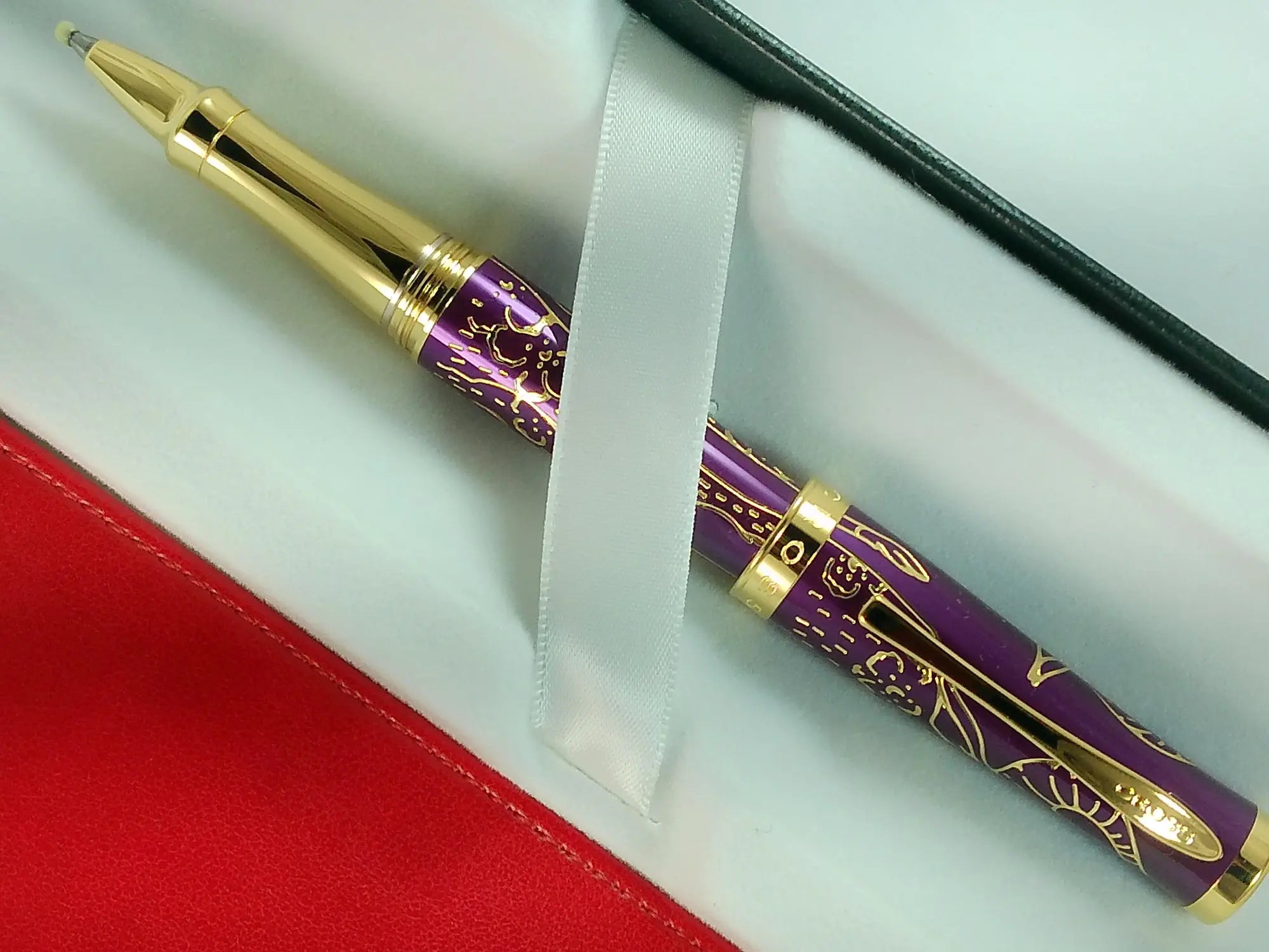 Cross Sauvage 2021 Year of the Ox Special-Edition, Hand-polished Translucent Plum lacquer finish with deep-etched ox engraving With 23KT Gold Plated Inlays and Appointments Selectip Rollerball Pen and Matching Pouch AT CROSS